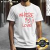 Pretty Where Is Love Red Text Shirt displayed on a wooden background, showcasing its vibrant color and unique design.