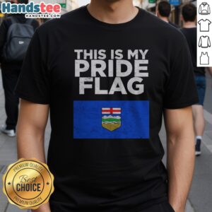 Top Alberta This Is My Pride Flag Nationalroast Shirt displayed on a hanger, showcasing vibrant colors and bold design.