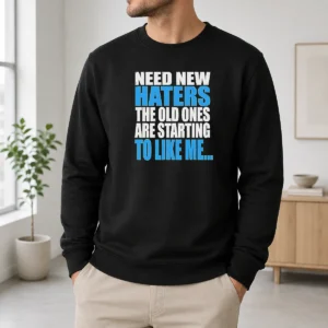 Hot Need New Haters The Old Ones Are Starting To Like Me Quote sweater in black with white text, cozy crewneck design