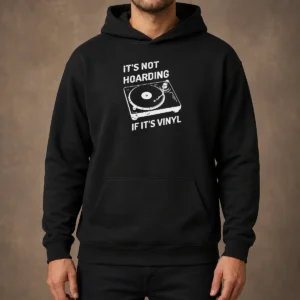 Hot It'S Not Hoarding If It'S Vinyl hoodie in black with front graphic print, displayed on a plain background