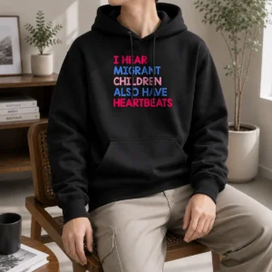 Awesome I Hear Migrant Children Also Have Heartbeats Hoodie in black, featuring bold white text on the front