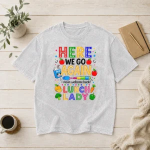 Funny Top Here We Go Again I Mean Welcome Back Lunch Lady printed on a soft washed t shirt in heather gray