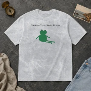 Original Frog I Am About To Crash Tf Out Meme printed on a soft washed t shirt in light gray