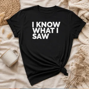 Hot I Know What I Saw graphic t shirt in black, featuring bold white text on front