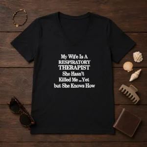 Top My Wife Is A Respiratory Therapist She Hasn'T Killed Me Yet But She Knows How V Neck Shirt in dark color with clear text