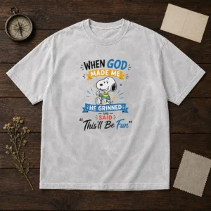 Official Snoopy Peanuts When God Made Me He Grinned And Said Thisll Be Fun washed t shirt in soft fabric with printed graphic