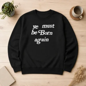 Premium Pharrell Williams Ye Must Be Born Again Sweater in black, featuring bold white text on front, long sleeves, and ribbed cuffs