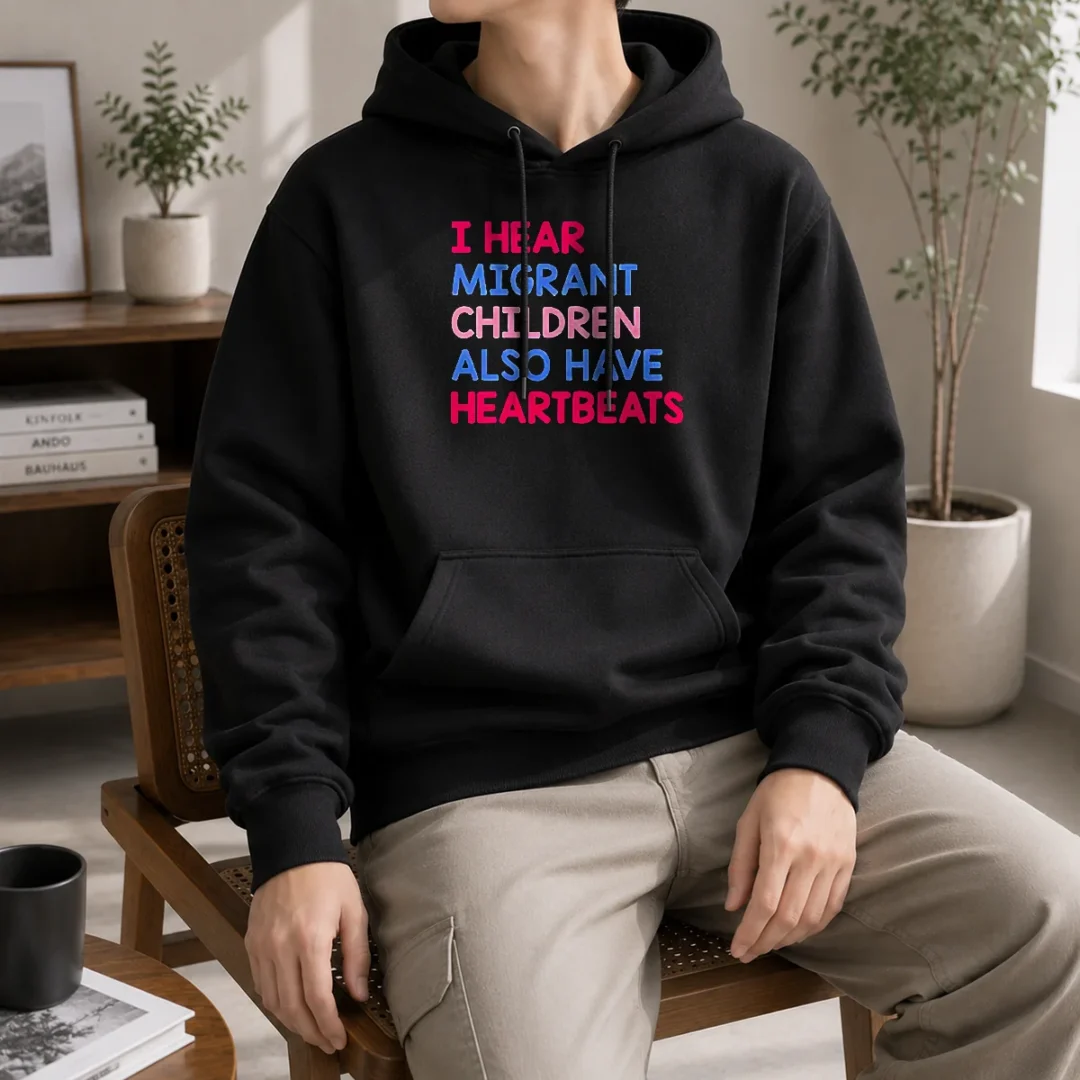 awesome-i-hear-migrant-children-also-have-heartbeats-hoodie Awesome I Hear Migrant Children Also Have Heartbeats Hoodie in black, featuring bold white text on the front