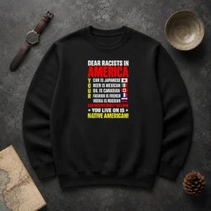Official Dear Racists In America You Live On Is Native American Sweater in charcoal gray, front view with bold white text design