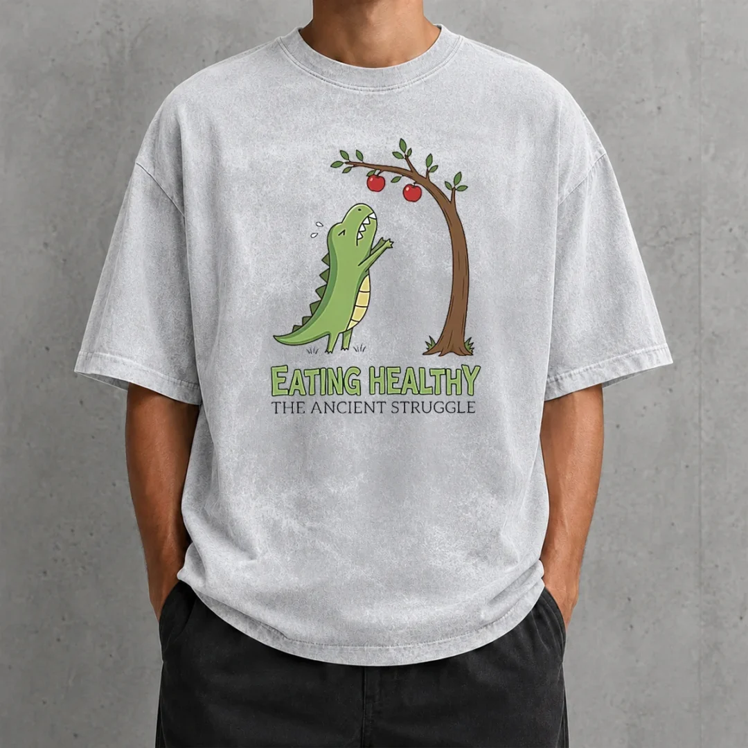 funny-t-rex-eating-healthy-the-ancient-struggle-washed-t-shirt Funny T Rex Eating Healthy The Ancient Struggle design on a soft washed t shirt in light gray