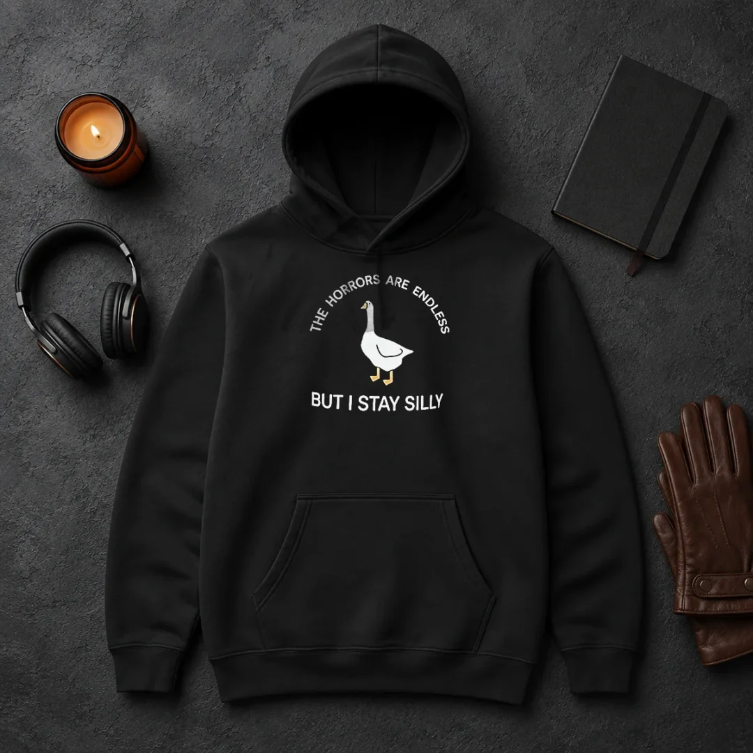 Hot Goose The Horrors Are Endless But I Stay Silly Hoodie Hot Goose The Horrors Are Endless But I Stay Silly Hoodie in black with front graphic print, long sleeves, and adjustable hood