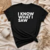 Hot I Know What I Saw graphic t shirt in black, featuring bold white text on front