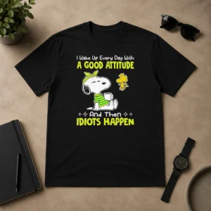 Original Top Snoopy I Wake Up Every Day With A Good Attitude And Then Idiots Happen t shirt in classic crew neck style