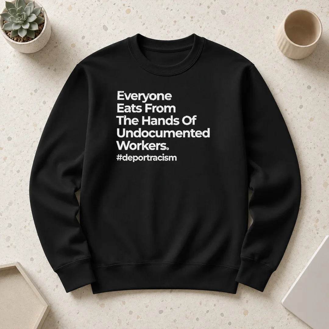 nice-everyone-eats-from-the-hands-of-undocumented-workers-deport-racism-statement-sweater Nice Everyone Eats From The Hands Of Undocumented Workers Deport Racism Statement sweater in dark color with bold white text on front