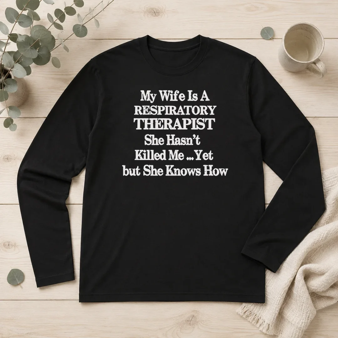 nice-official-my-wife-is-a-respiratory-therapist-she-hasn-t-killed-me-yet-but-she-knows-how-long-sleeve-shirt Nice Official My Wife Is A Respiratory Therapist She Hasn'T Killed Me Yet But She Knows How Long Sleeve Shirt in dark color with bold white text