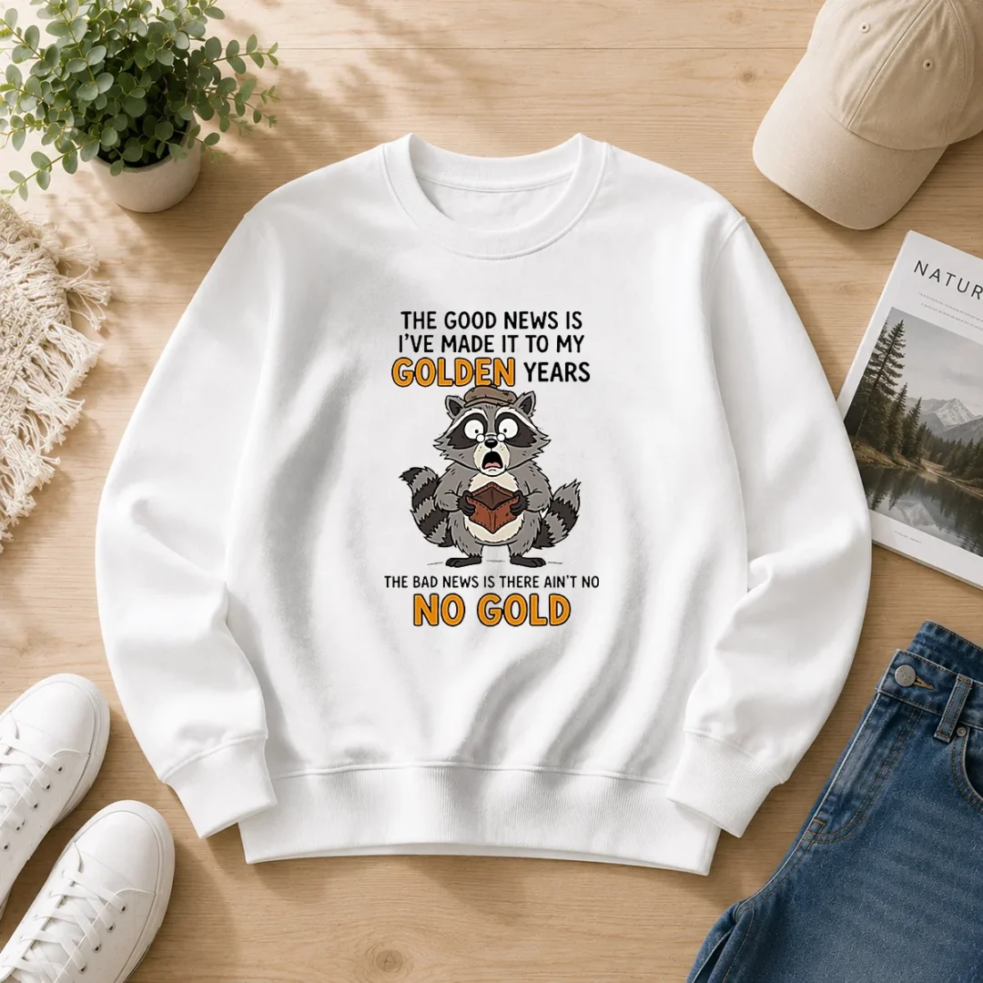 nice-raccoon-the-good-news-is-ive-made-it-to-my-golden-years-the-bad-news-is-there-aint-no-no-g-sweater Nice Raccoon The Good News Is Ive Made It To My Golden Years The Bad News Is There Aint No No G cozy sweater with printed text on front