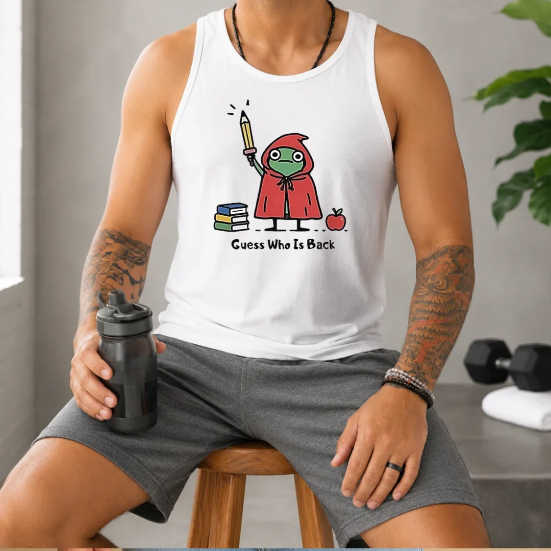 premium-guess-who-is-back-frog-with-pencil-and-books-tank-top Premium Guess WHO Is Back Frog With Pencil And Books Tank Top showing vibrant frog illustration with pencil and books on a sleeveless cotton garment