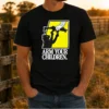 Pretty Black Cat With Gun Satire Arm Your Children t shirt in black, featuring a bold graphic design on a classic crew neck