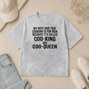 Nice Good My Wife Said That Cooking Is For Men Because It Is Called Coo King Not Coo Queen printed on a washed t shirt in white color