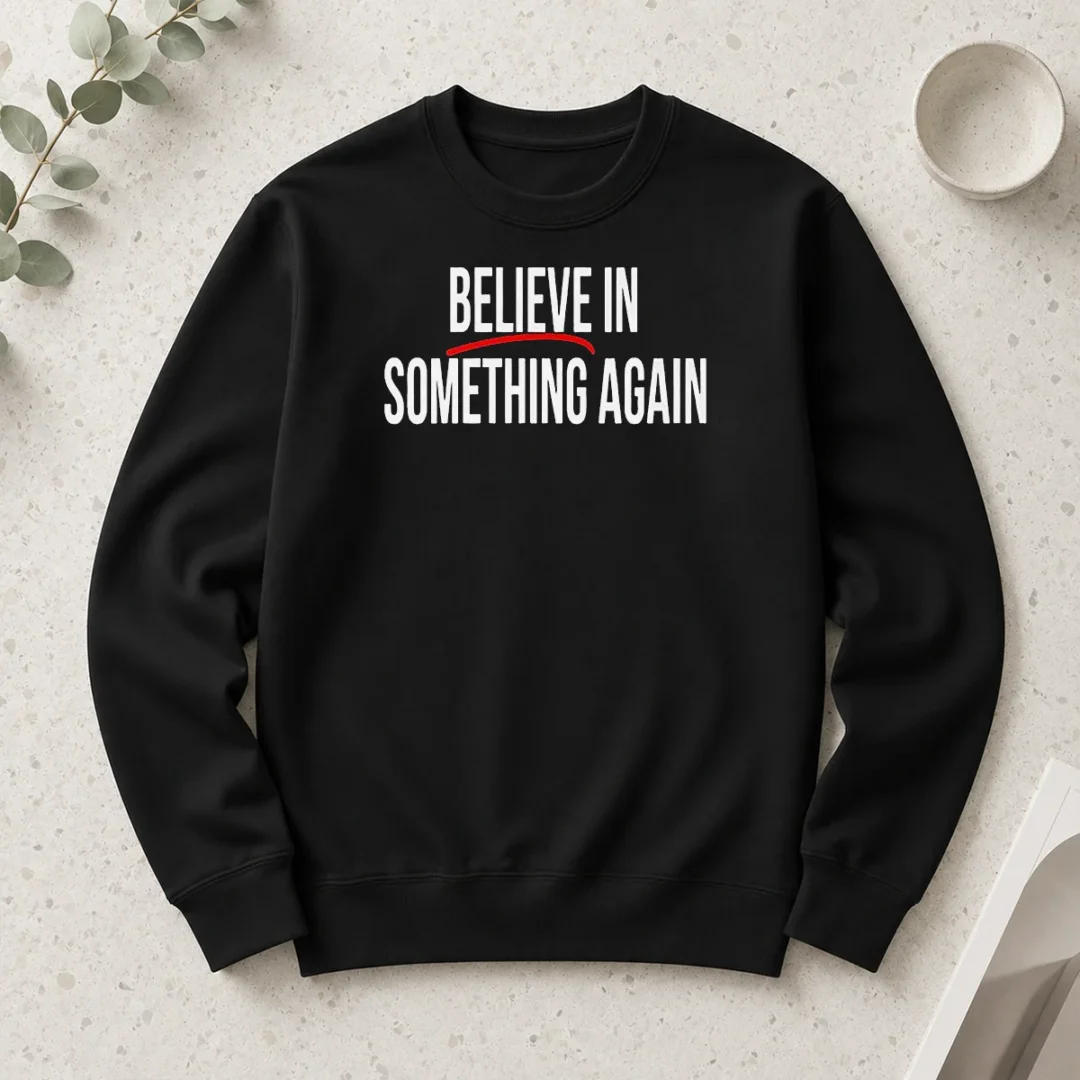 top-believe-in-something-again-long-sleeve-shirt Top Believe In Something Again long sleeve shirt in black, front view with printed slogan