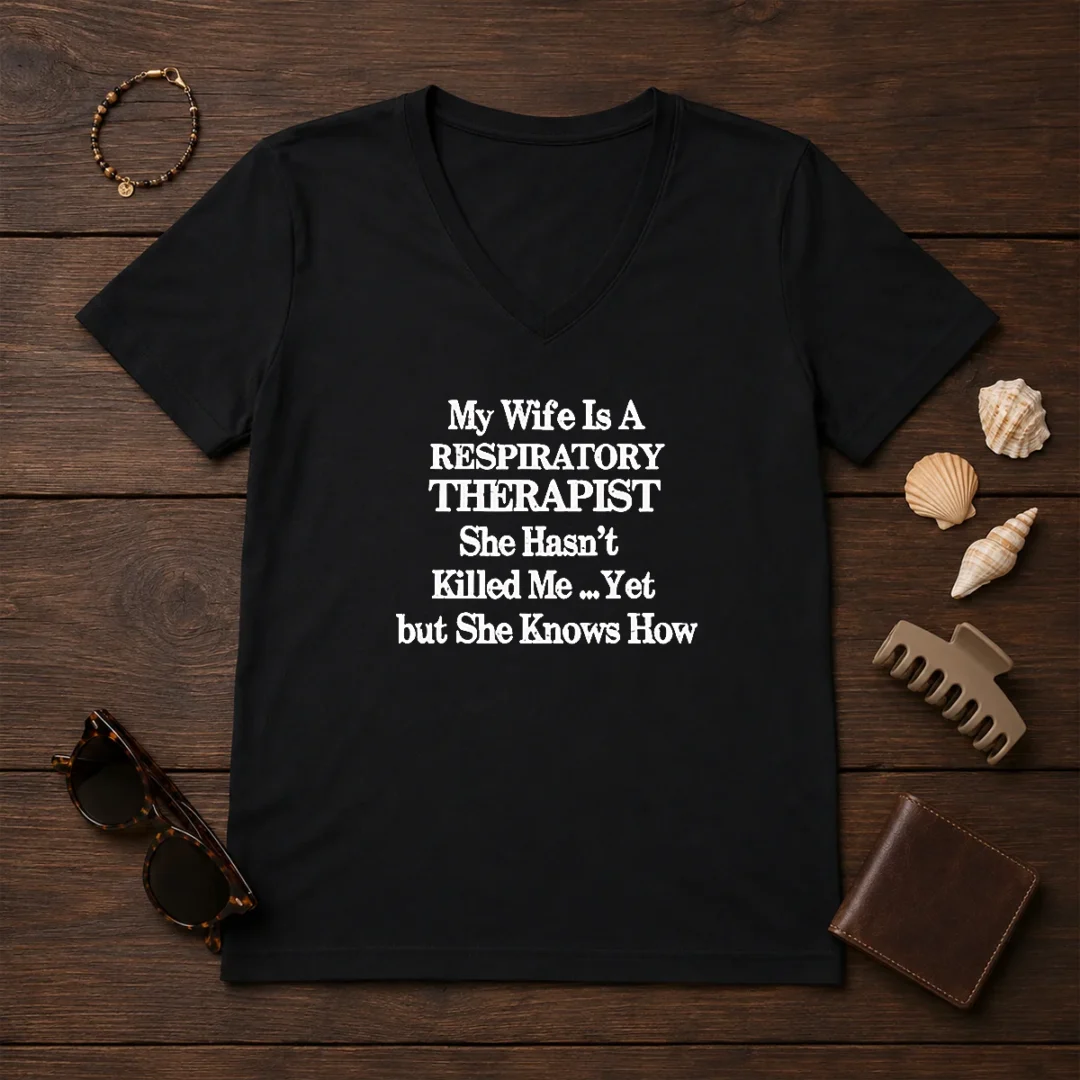 top-my-wife-is-a-respiratory-therapist-she-hasn-t-killed-me-yet-but-she-knows-how-v-neck-shirt-2 Top My Wife Is A Respiratory Therapist She Hasn'T Killed Me Yet But She Knows How V Neck Shirt in dark color with clear text